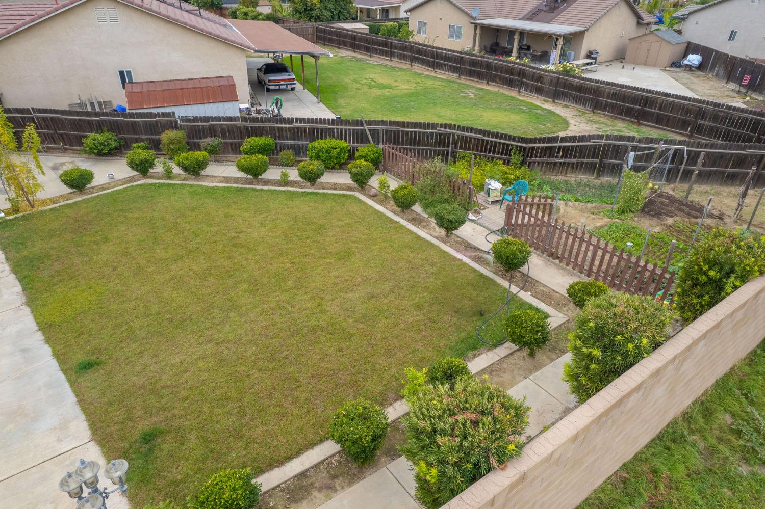 1002 Sequoia Court Fowler, CA 93625 - Photo 12 of 54 a view of a swimming pool with a fountain and plants