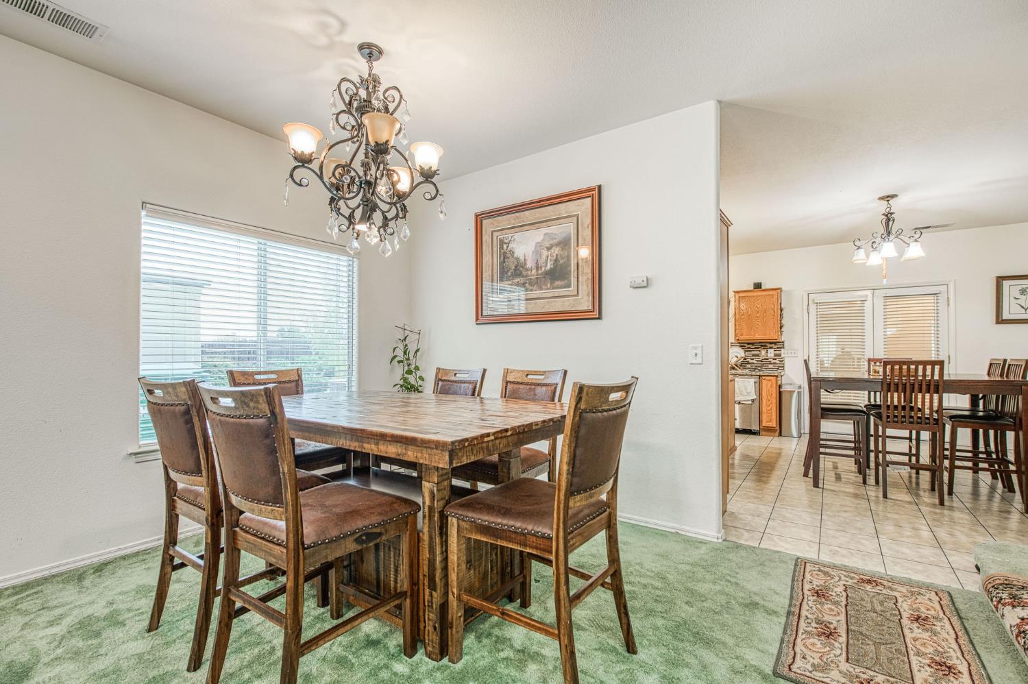 1002 Sequoia Court Fowler, CA 93625 - Photo 29 of 54 a view of a dining room with furniture and chandelier