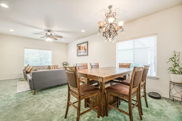 a view of a dining room with furniture and chandelier