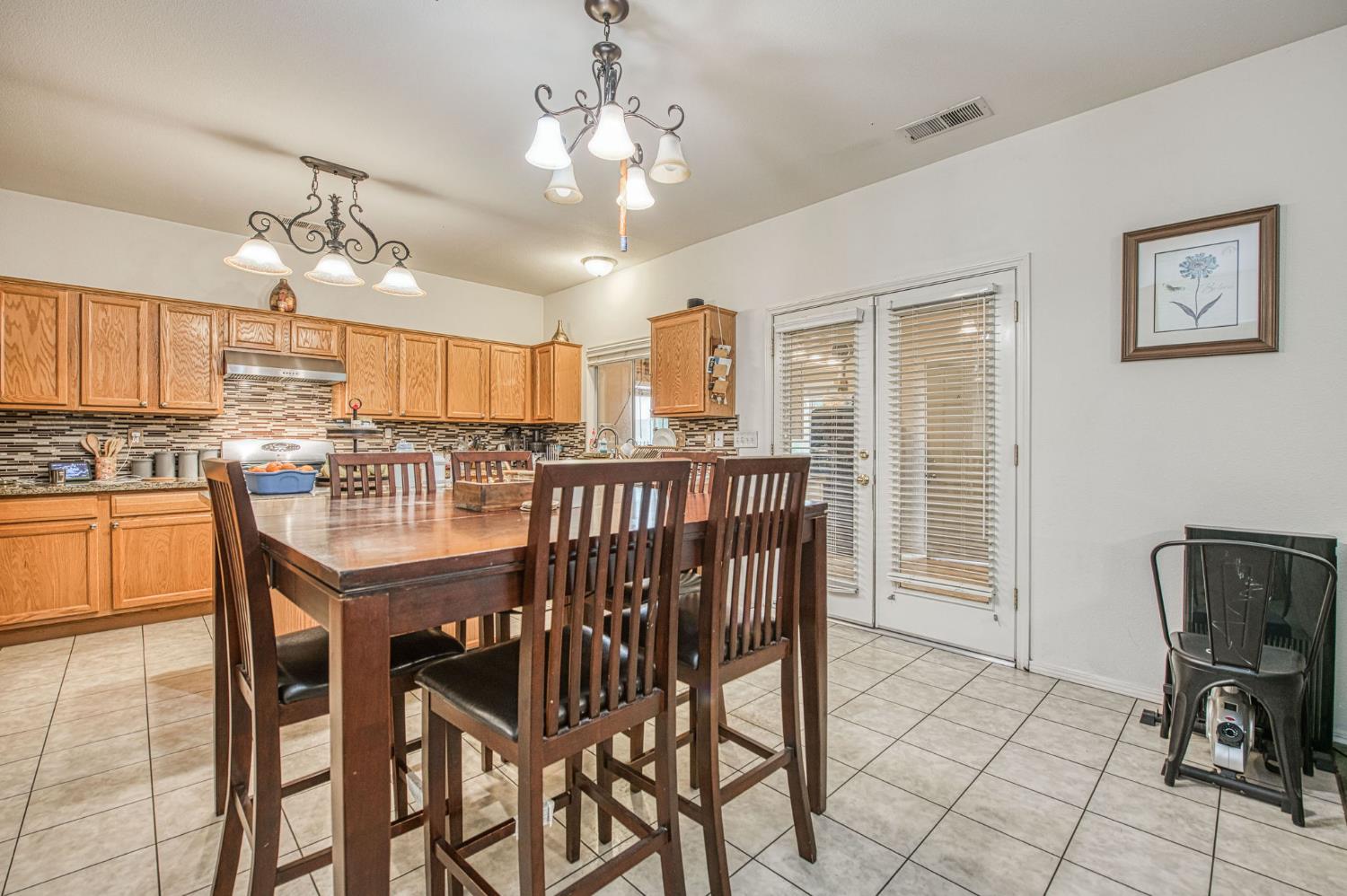 1002 Sequoia Court Fowler, CA 93625 - Photo 35 of 54 a view of a dining room with furniture and a chandelier