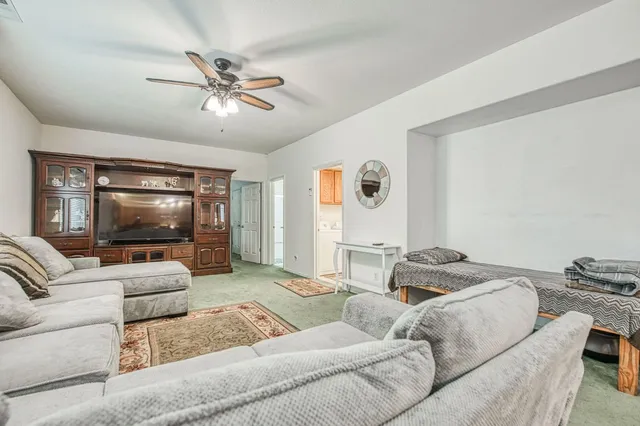 a living room with furniture and a clock