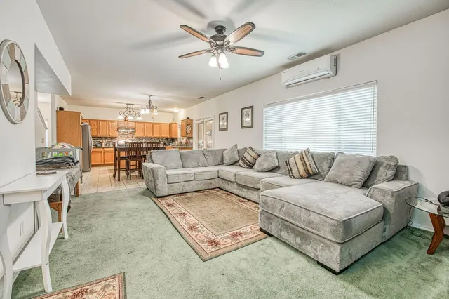 a bathroom with a granite countertop sink mirror vanity and toilet