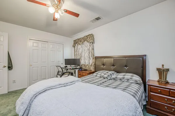a bedroom with a large bed and a window