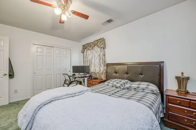 a bedroom with a large bed and a window