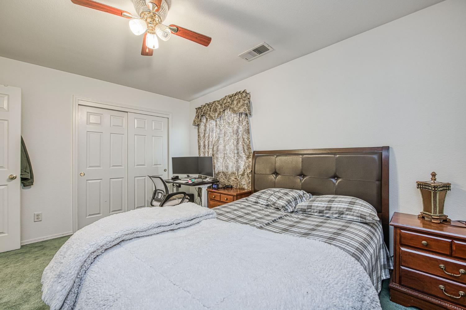 1002 Sequoia Court Fowler, CA 93625 - Photo 47 of 54 a bedroom with a bed and a chandelier