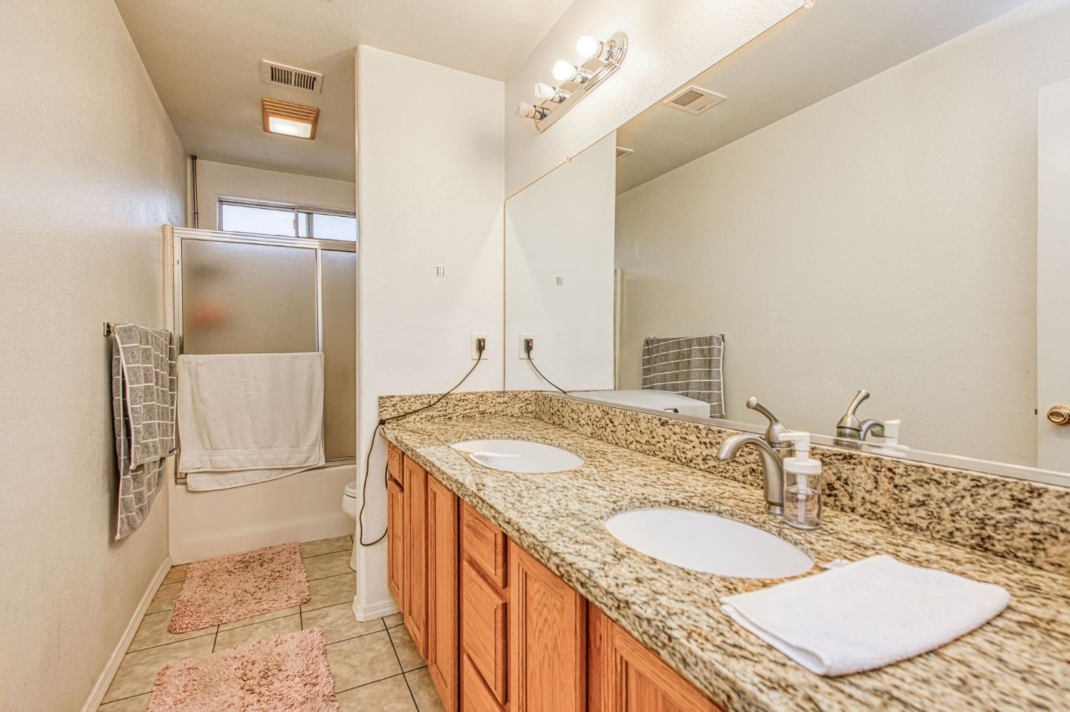1002 Sequoia Court Fowler, CA 93625 - Photo 48 of 54 a bathroom with a sink and a mirror