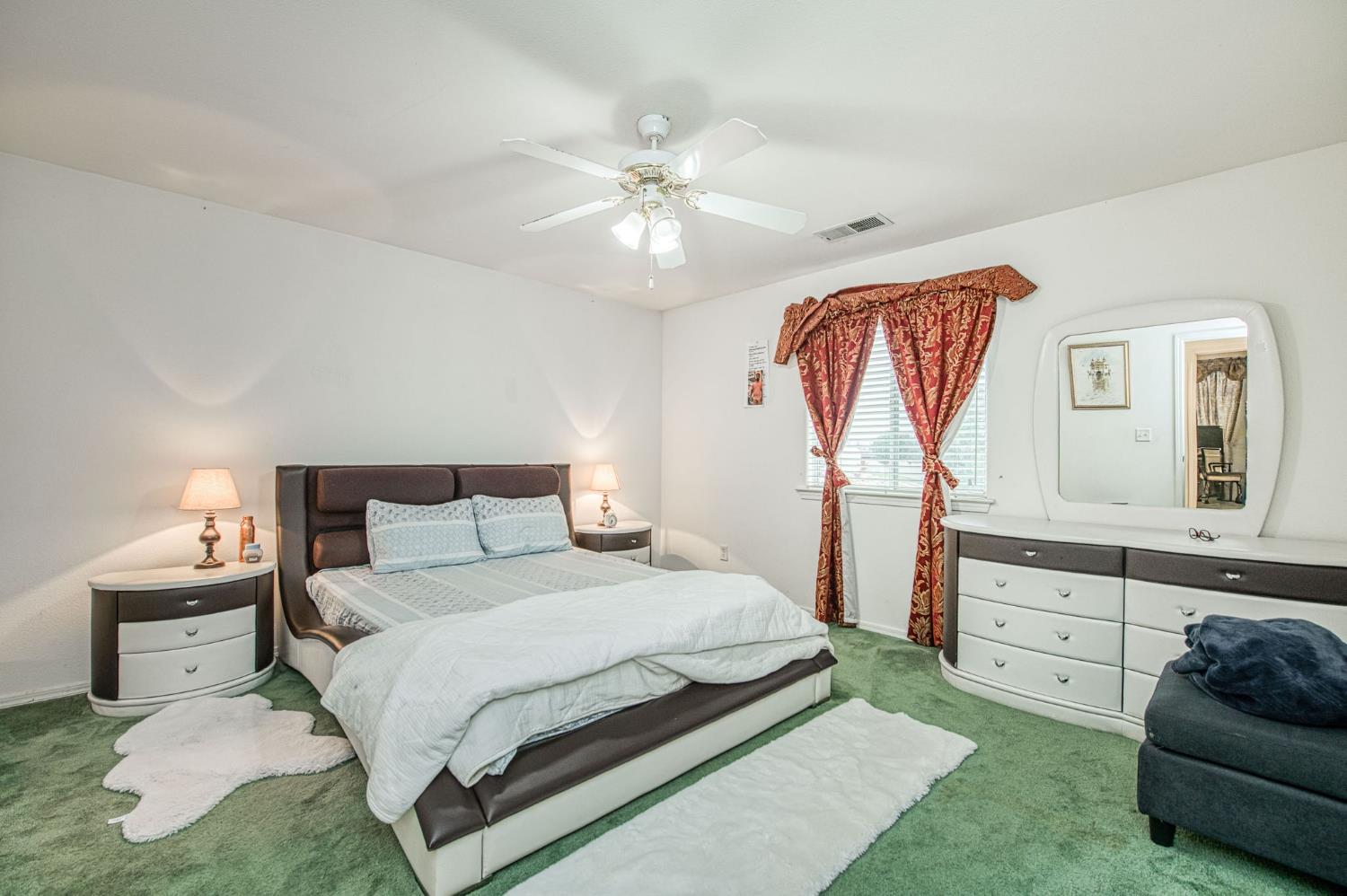 1002 Sequoia Court Fowler, CA 93625 - Photo 49 of 54 a bedroom with a bed and a couch