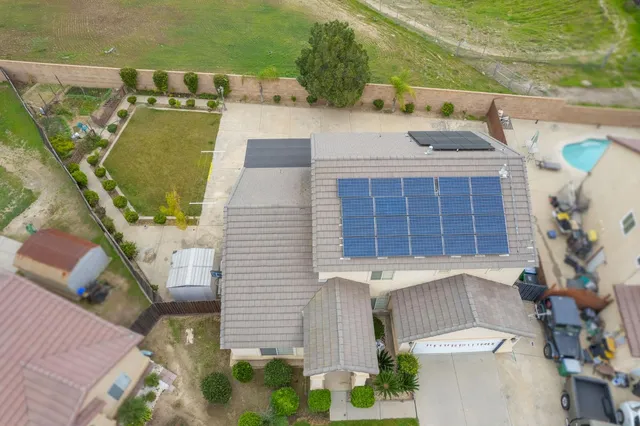 an aerial view of a house with swimming pool and outdoor space