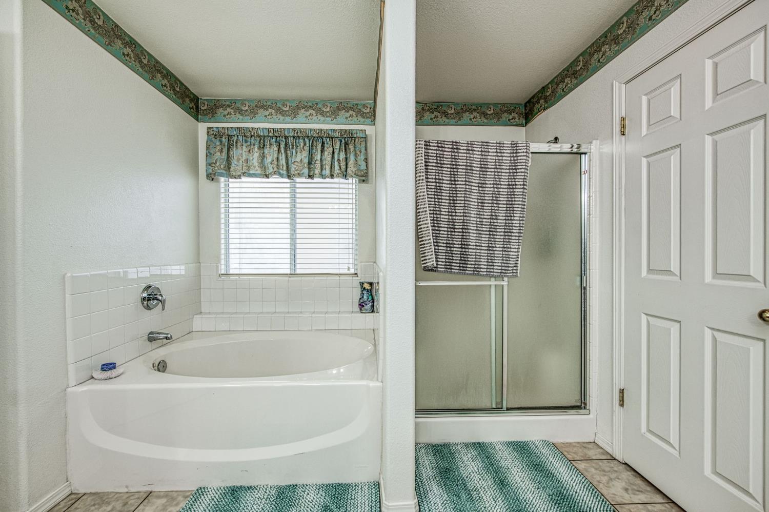1002 Sequoia Court Fowler, CA 93625 - Photo 53 of 54 a bathroom with a bathtub and a shower