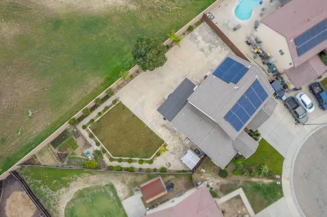 an aerial view of a house with a yard