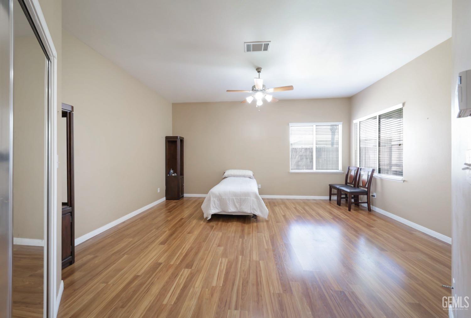 Undisclosed Address Bakersfield, CA 93313 - Photo 11 of 29 an empty room with wooden floor and windows