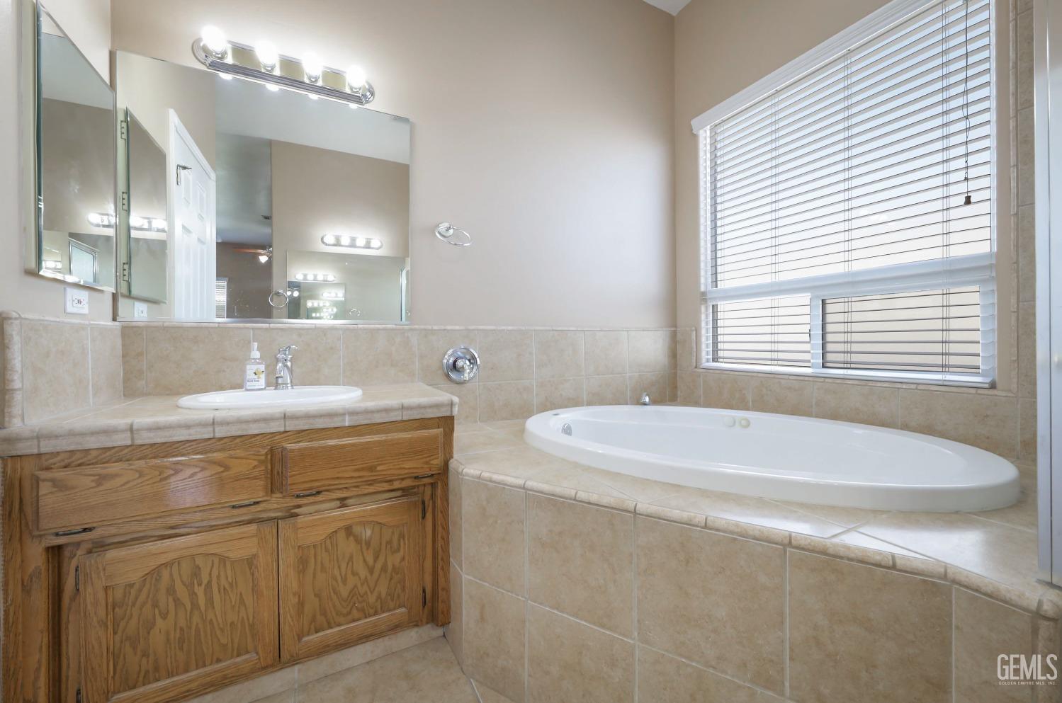 Undisclosed Address Bakersfield, CA 93313 - Photo 14 of 29 a bath room with a sink and a mirror