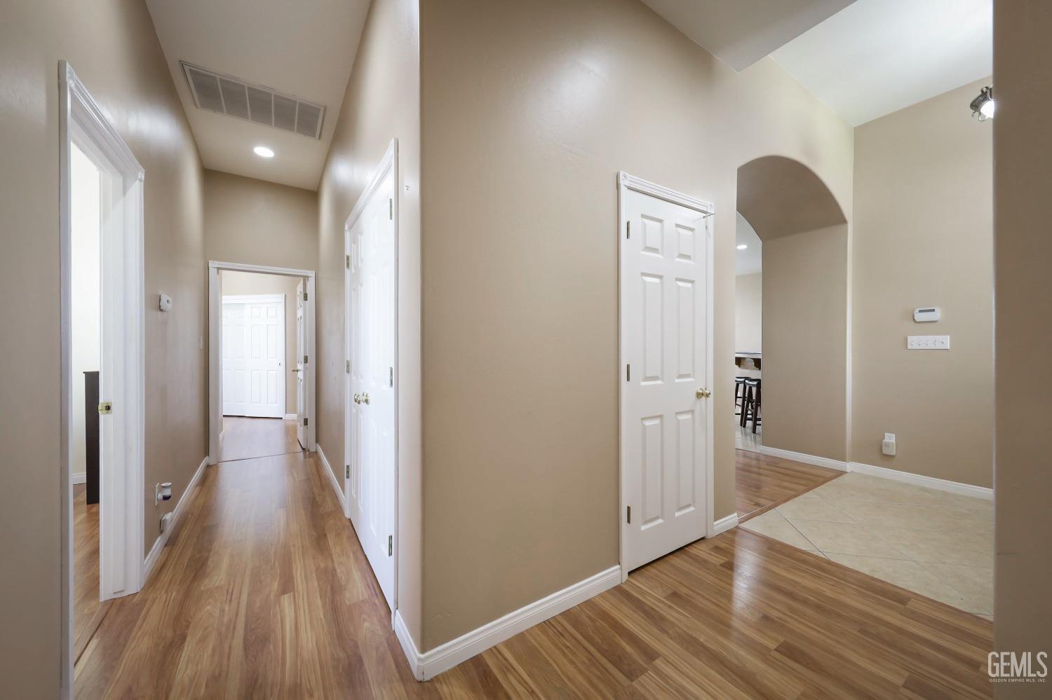Undisclosed Address Bakersfield, CA 93313 - Photo 15 of 29 a view of a hallway with wooden floor and closet