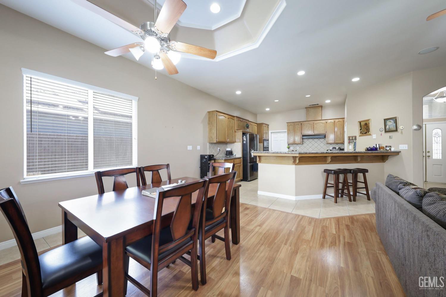 Undisclosed Address Bakersfield, CA 93313 - Photo 18 of 29 a view of a dining room with furniture and wooden floor
