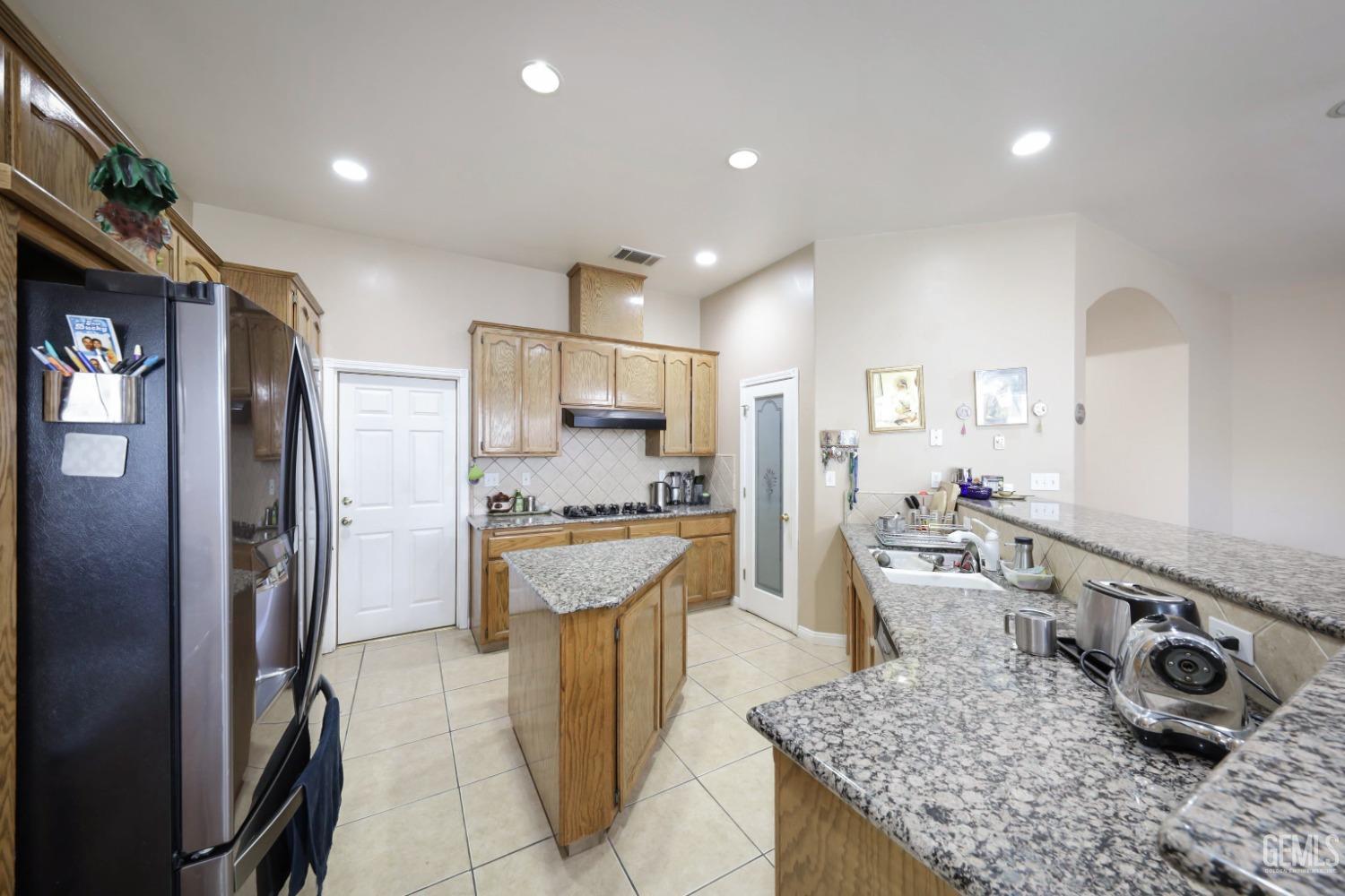 Undisclosed Address Bakersfield, CA 93313 - Photo 20 of 29 a kitchen with stainless steel appliances granite countertop a refrigerator a stove and a sink
