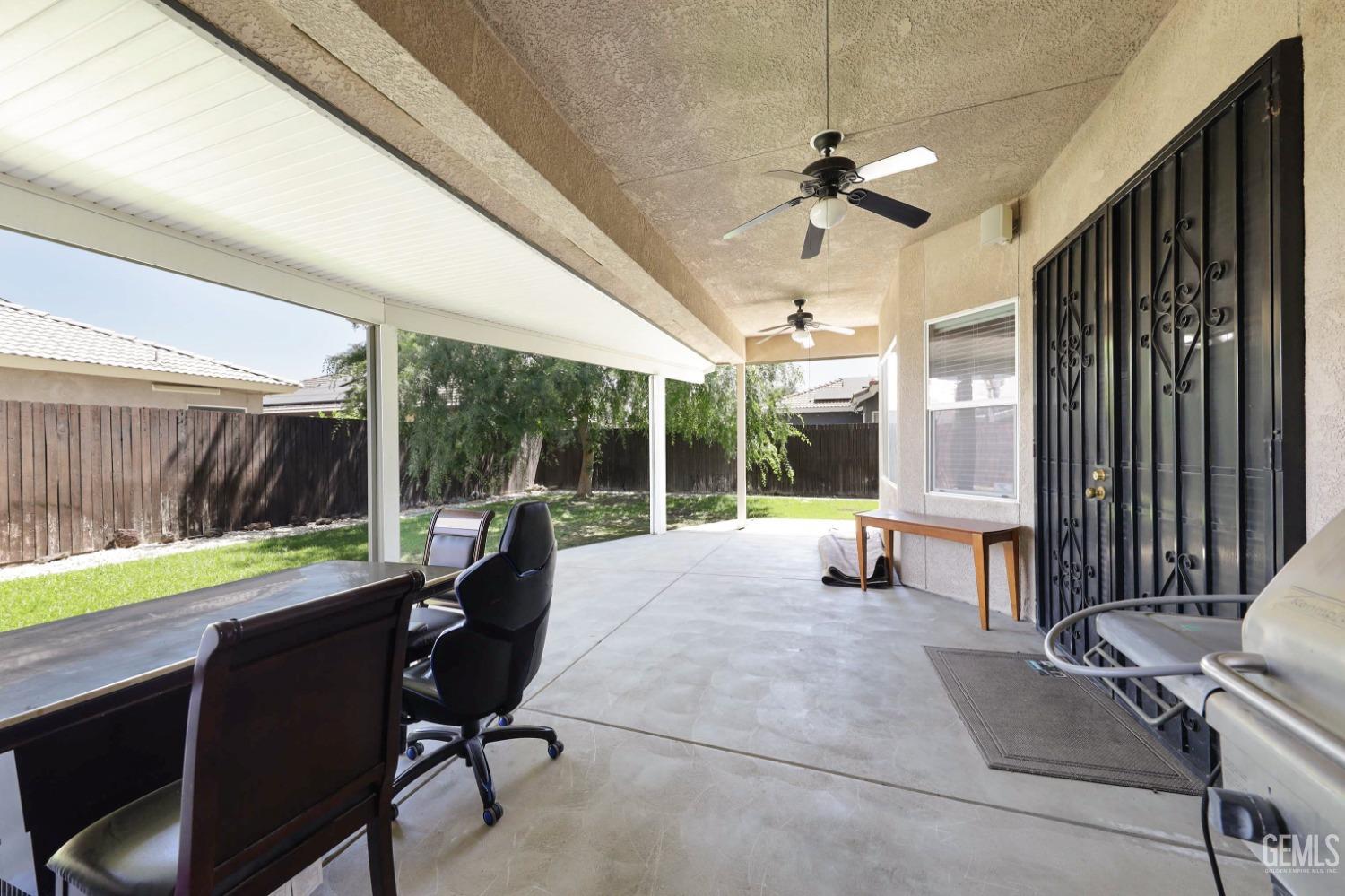 Undisclosed Address Bakersfield, CA 93313 - Photo 23 of 29 a view of a patio with a table chairs and a backyard