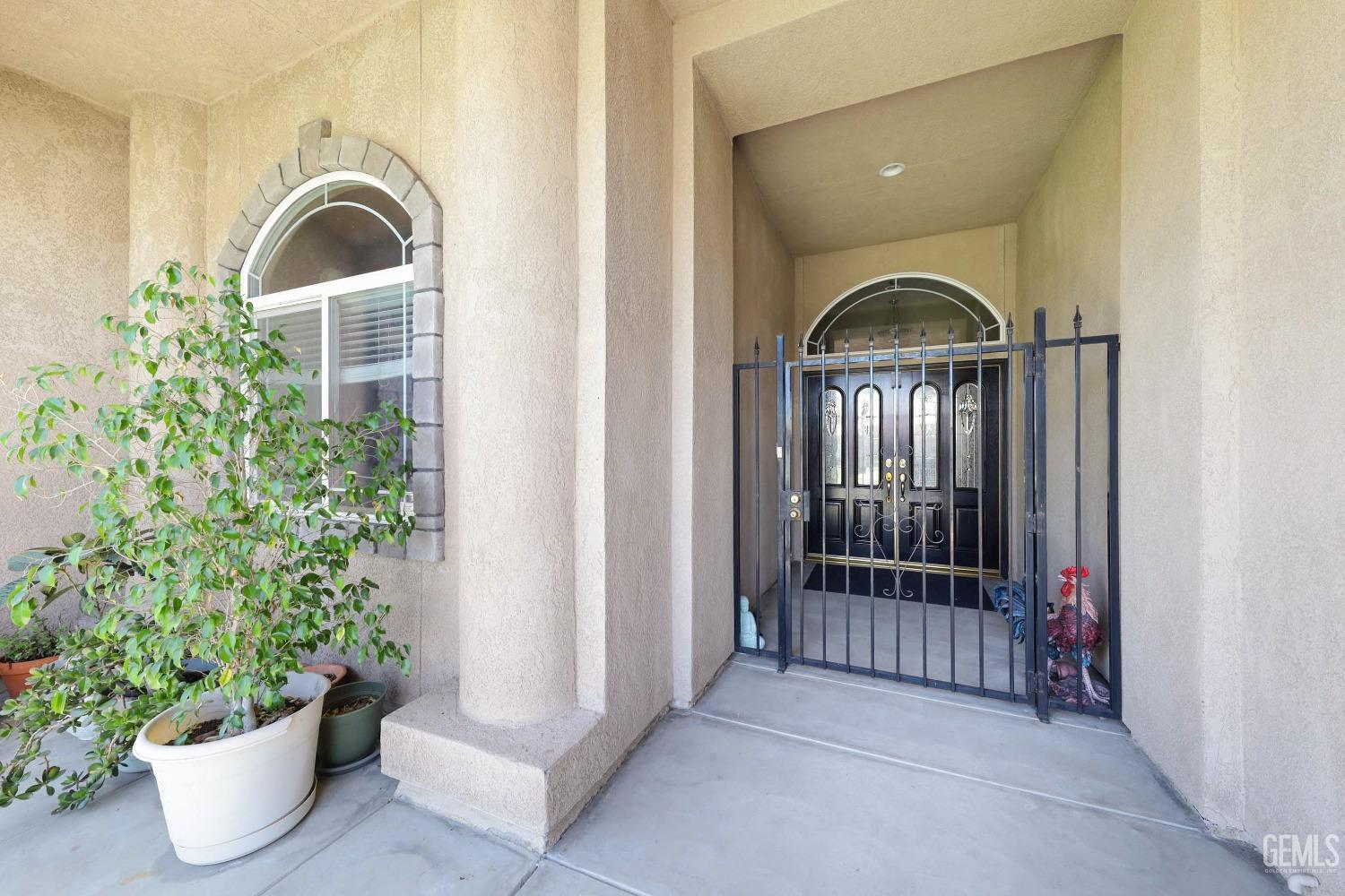 Undisclosed Address Bakersfield, CA 93313 - Photo 3 of 29 a view of a room that has a large window and flower pot