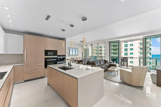a kitchen that has a sink and a stove top oven