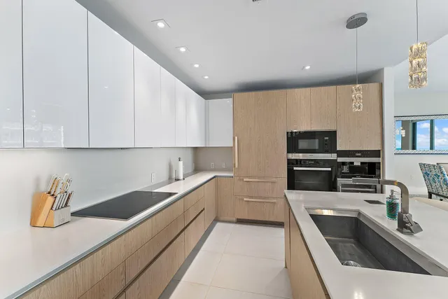 a kitchen with stainless steel appliances a stove a sink and a microwave