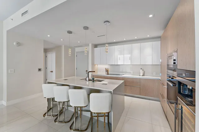 a kitchen with kitchen island wooden cabinets and stainless steel appliances