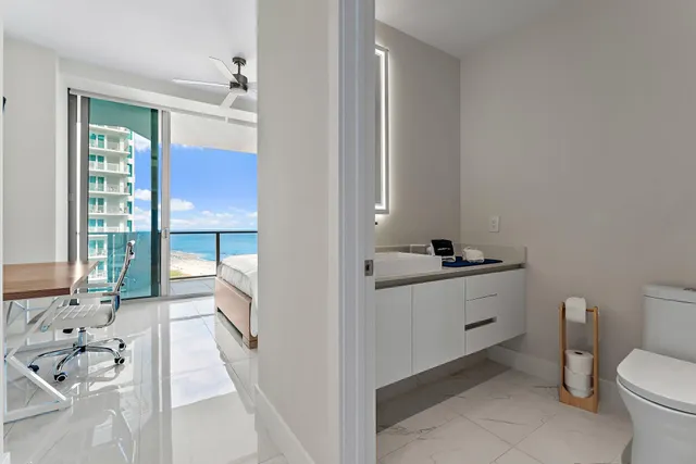 a bathroom with a sink toilet and mirror