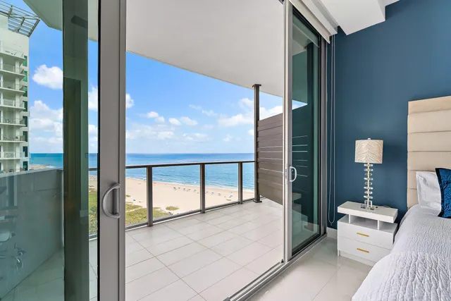 a bedroom with a bed window and a flat screen tv