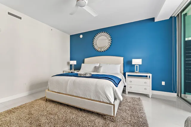 a bedroom with a bed and chandelier