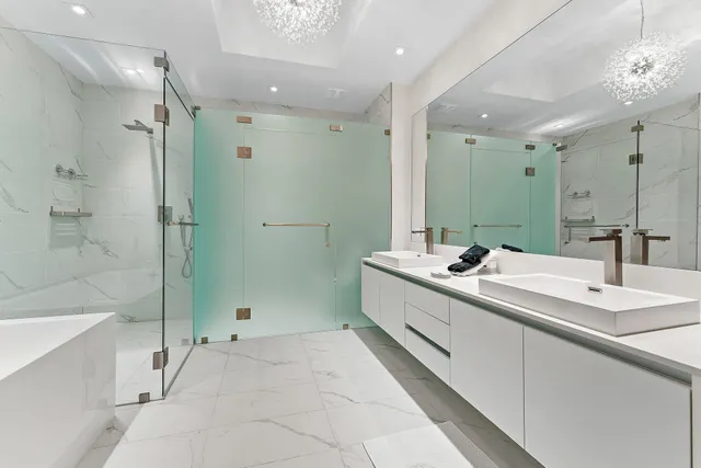 a bathroom with a double vanity sink mirror and shower