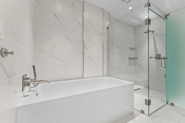 a bathroom with a bathtub and a shower
