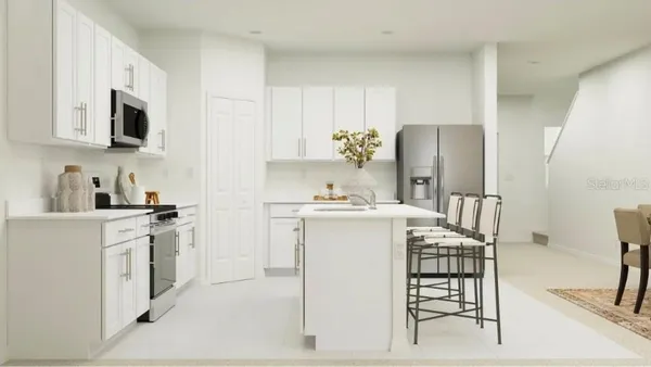 a kitchen with stainless steel appliances a refrigerator sink and microwave