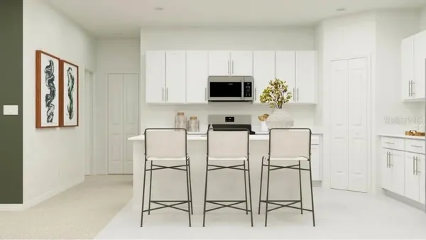 a white kitchen with stainless steel appliances and white cabinets