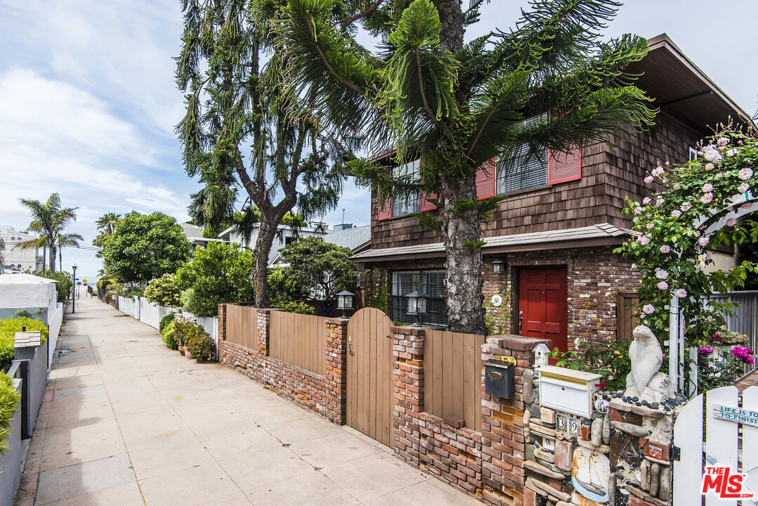 a front view of a house with a tree