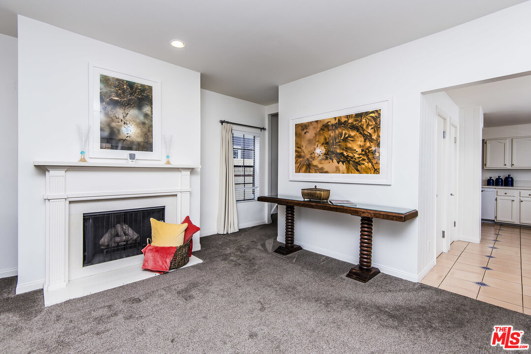 27 30th Avenue Venice, CA 90291 - Photo 12 of 49 a living room with furniture a fireplace and wall paintings