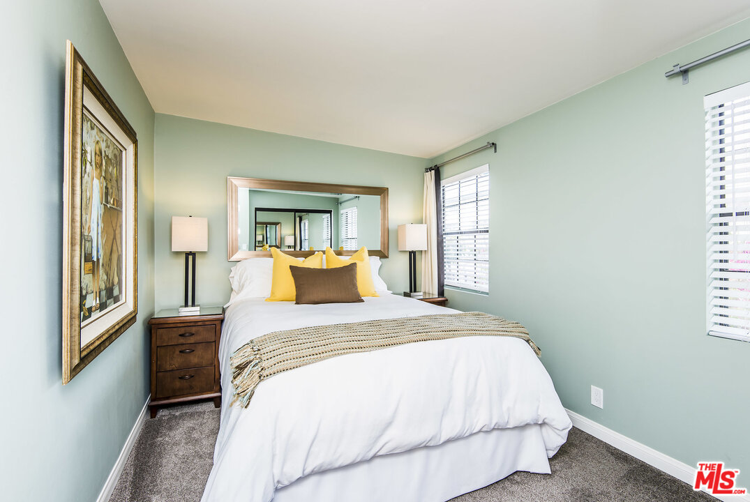 27 30th Avenue Venice, CA 90291 - Photo 27 of 49 a bedroom with a bed wooden floor and windows