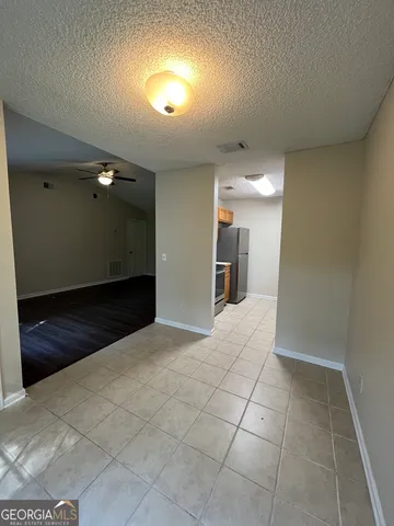 a view of a hallway to rooms