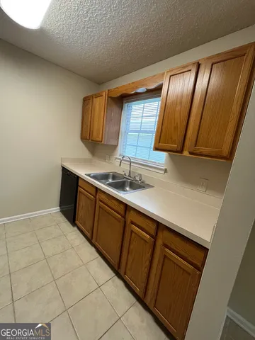 a kitchen with granite countertop cabinets and window