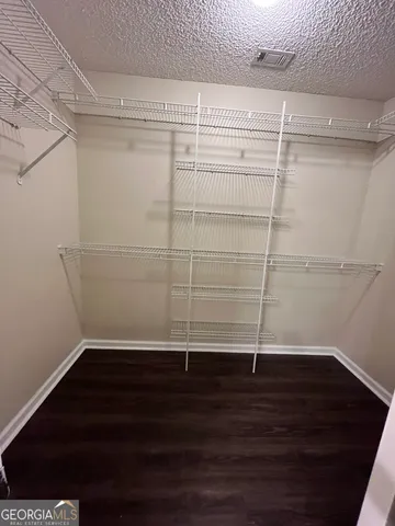 a view of a room with wooden floor