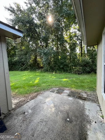 a view of a backyard with large trees