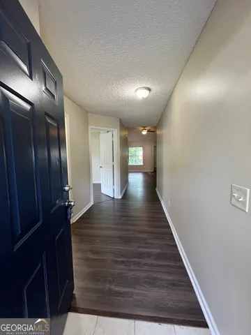 a view of gallery with wooden floor