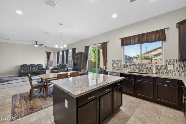 a kitchen with a stove a refrigerator a kitchen island a sink and a oven