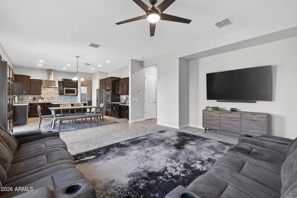 a living room with furniture and a ceiling fan