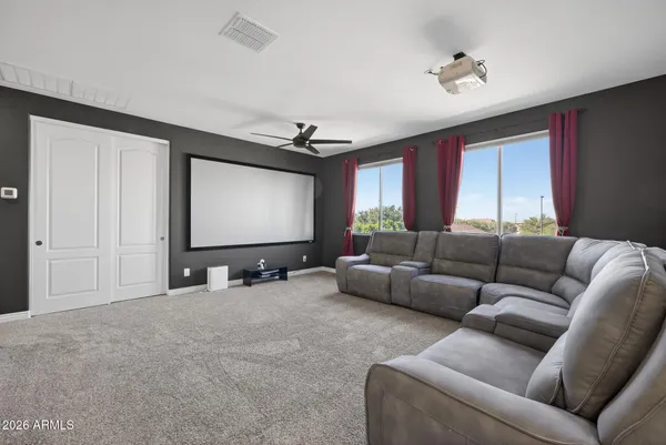 a living room with furniture and a ceiling fan