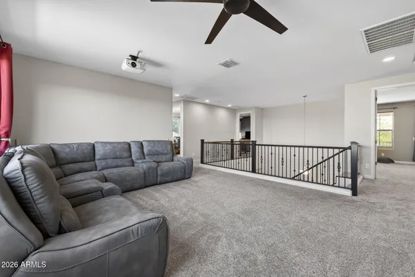 a spacious bedroom with a bed and a chandelier