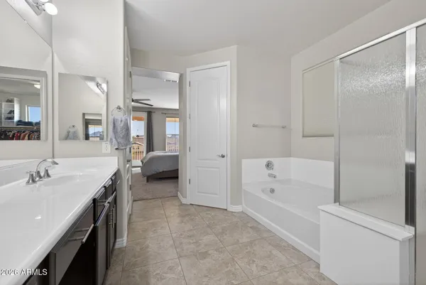 a bathroom with a sink a toilet a mirror and shower