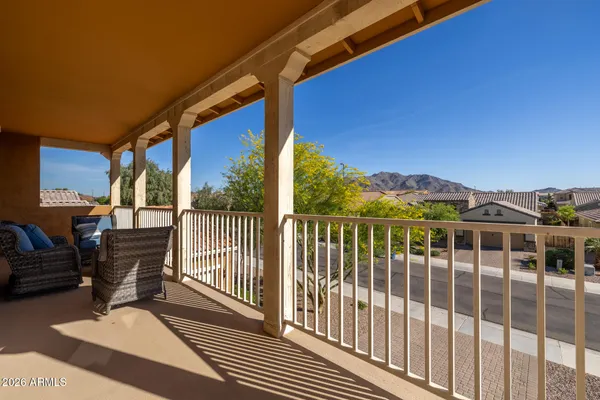a view of a house with a yard plants and large tree