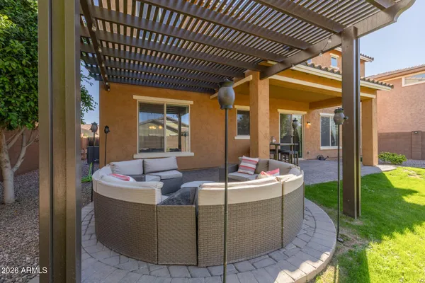 a view of a swimming pool with lawn chairs under an umbrella