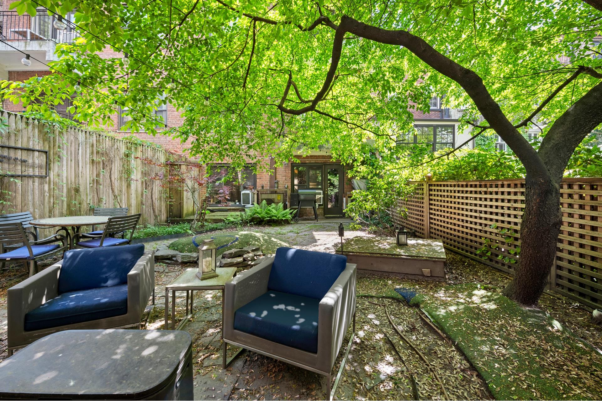 a view of backyard with outdoor seating and trees