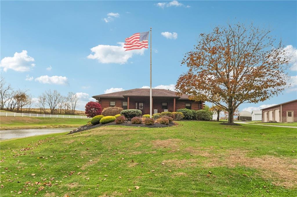 a view of a house with a yard and swimming pool