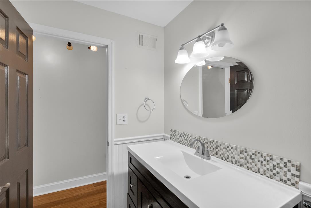 3396 Darien Road Bethlehem, PA 18020 - Photo 22 of 44 A sleek modern vanity with a stylish tile backsplash elevates this bright bathroom.