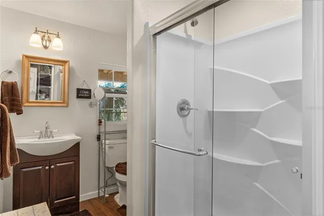 a bathroom with a glass shower door
